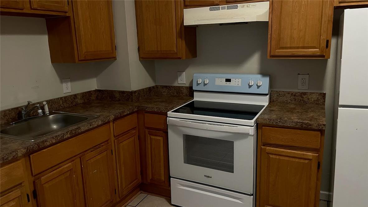 1103 Butler Street Easton, PA 18042 - Photo 5 of 9 a kitchen with granite countertop white cabinets and white appliances