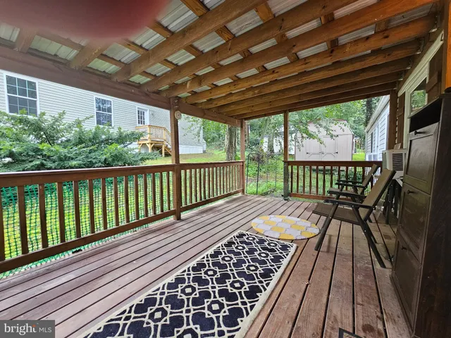 a view of balcony with wooden floor