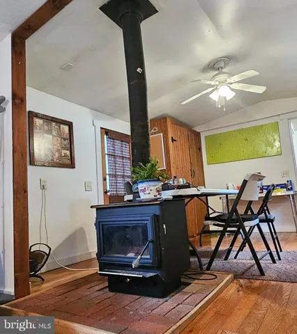a living room with furniture a piano and a fireplace