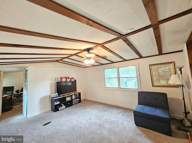 a living room with dining room and wooden floor