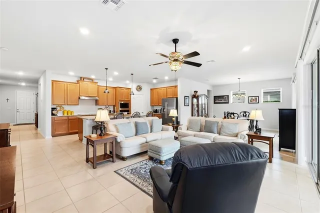 a living room with lots of furniture and kitchen view
