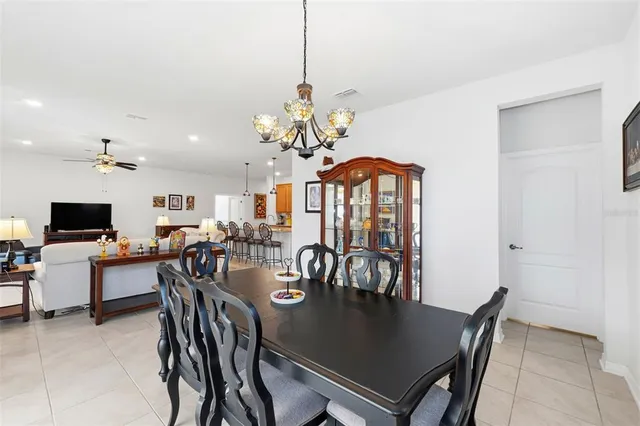 a view of a dining room with furniture and a chandelier