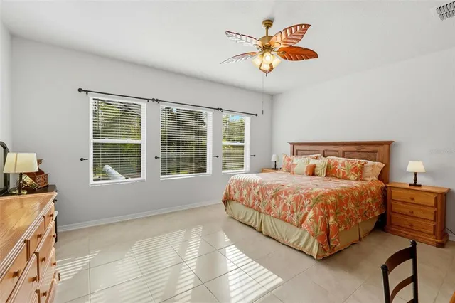 a bedroom with a bed and a large window