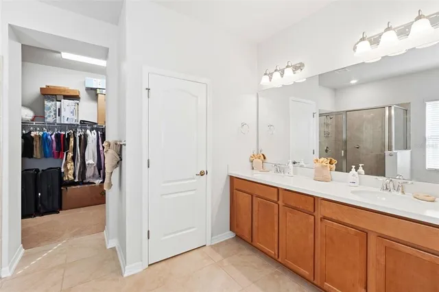 a bathroom with a double vanity sink and a mirror