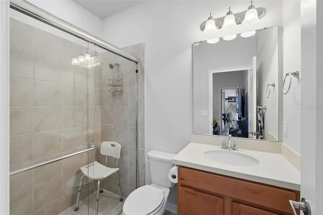 a bathroom with a sink toilet a mirror and shower