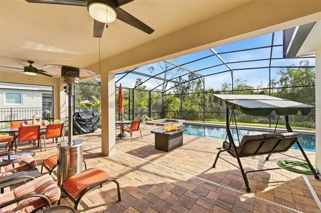 a view of a patio with a table and chairs under an umbrella