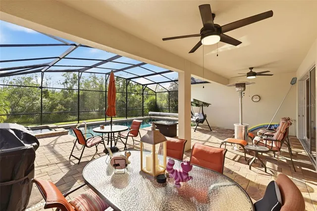 a view of a patio with a dining table and chairs