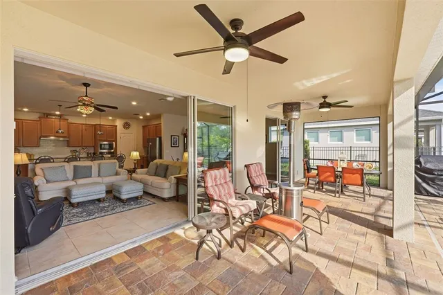 a living room with patio furniture and a large window