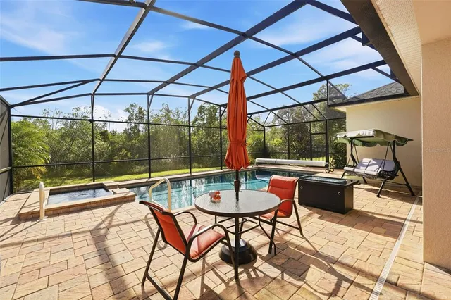 a view of a patio with a dining table and chairs