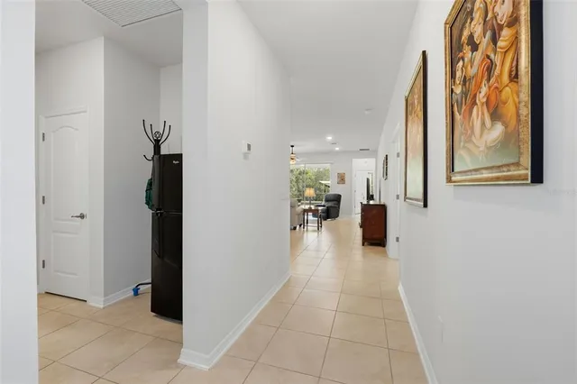 a view of a hallway with a dining table and a utility room