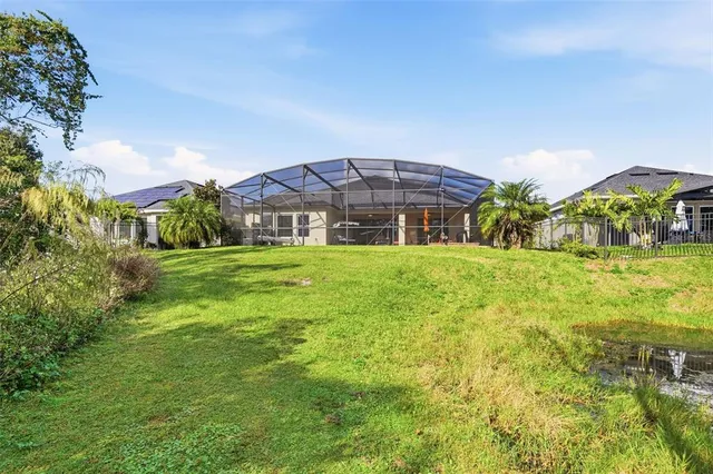 a front view of a house with a yard and fountain in middle