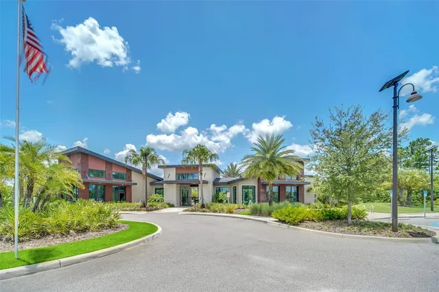 a living room with furniture kitchen view and a large window