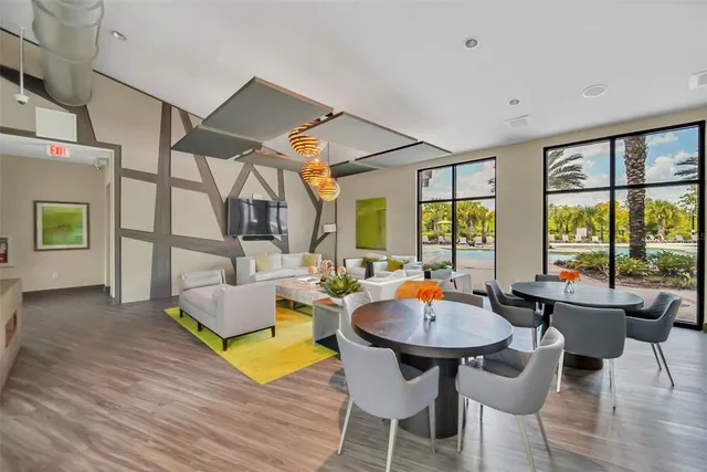 a view of a white house with a swimming pool and a yard