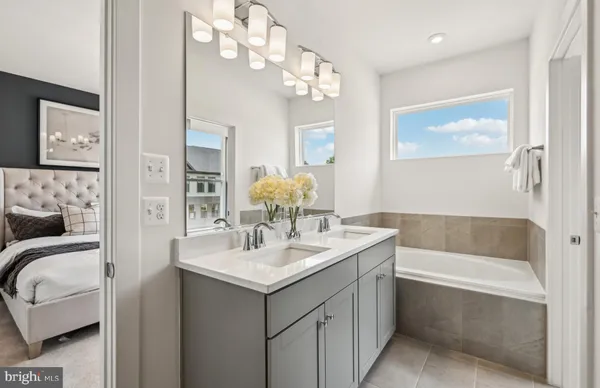 a bathroom with a double vanity sink and a mirror