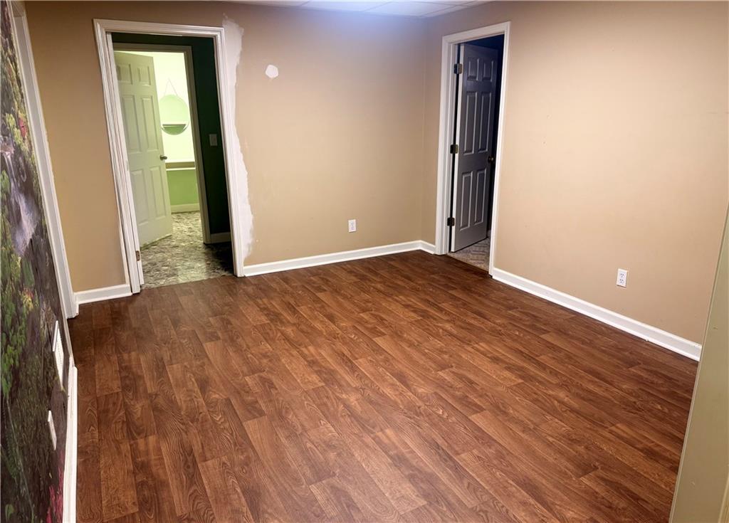 4823 Stephens Road Gainesville, GA 30504 - Photo 25 of 47 an empty room with wooden floor and windows