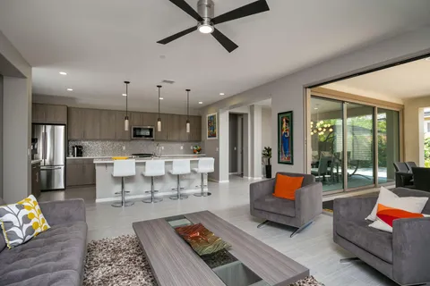 a living room with furniture and a view of kitchen