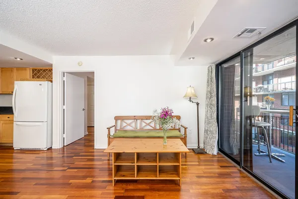a spacious bedroom with a bed and a flat screen tv