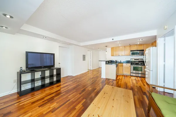 a kitchen with a sink a refrigerator and a stove top oven