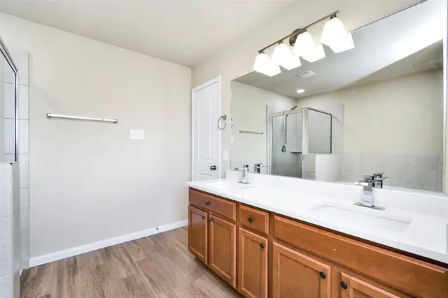 a bathroom with a sink a light fixture and a mirror