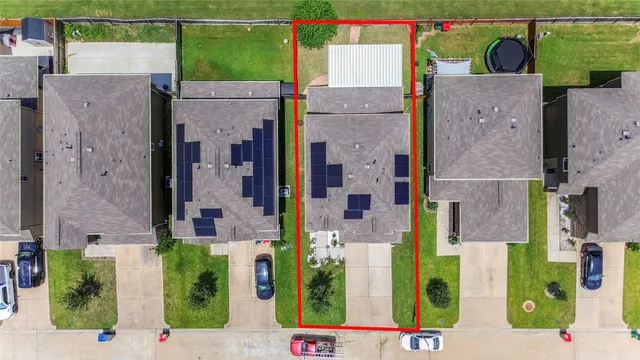 an aerial view of residential houses with outdoor space