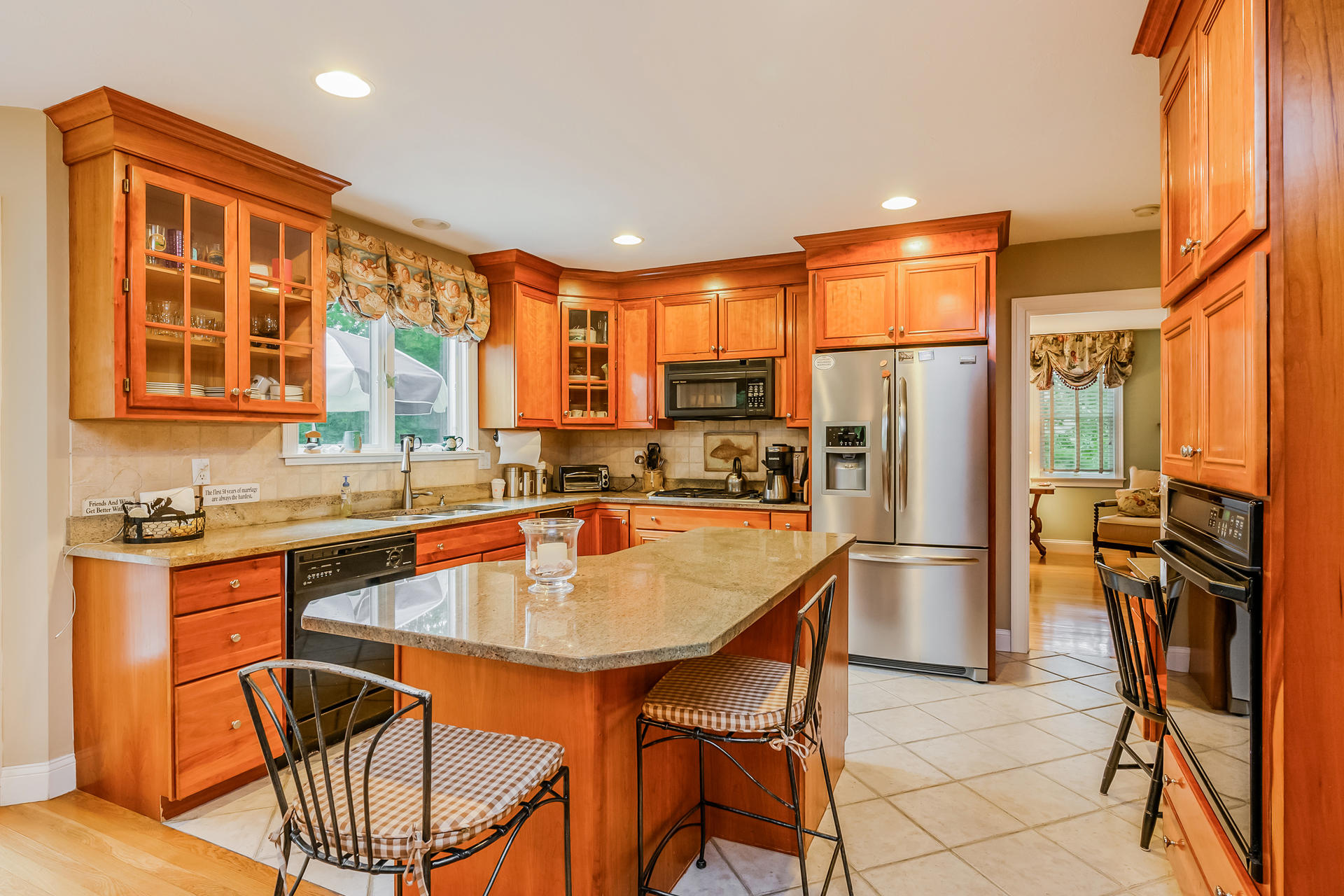 112 Cairn Ridge Road East Falmouth, MA 02536 - Photo 8 of 31 a kitchen with stainless steel appliances granite countertop a refrigerator a stove a sink a dining table and chairs with wooden floor