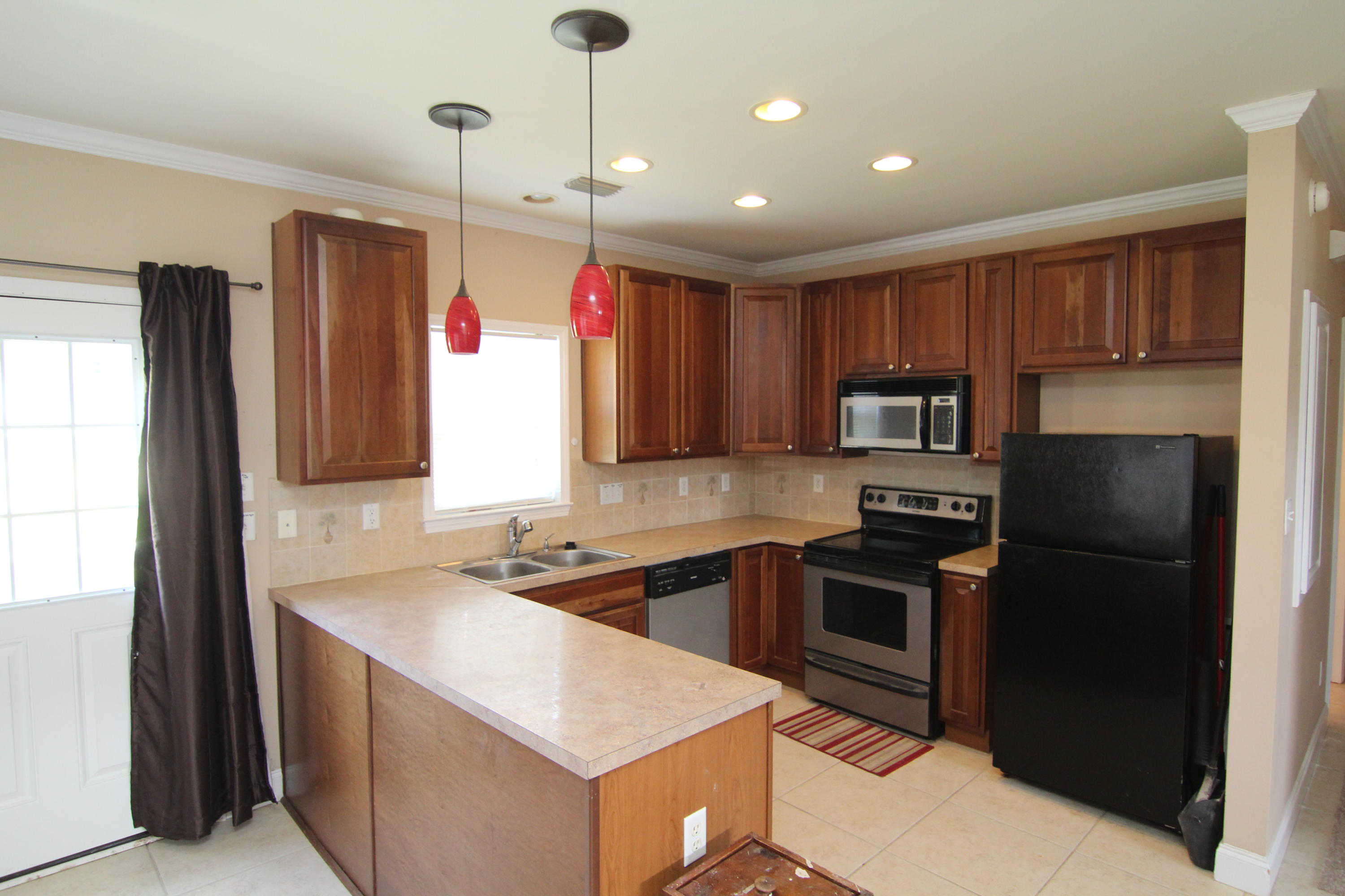 161 6th Street Santa Rosa Beach, FL 32459 - Photo 3 of 13 a kitchen that has a sink stainless steel appliances a counter space and a window