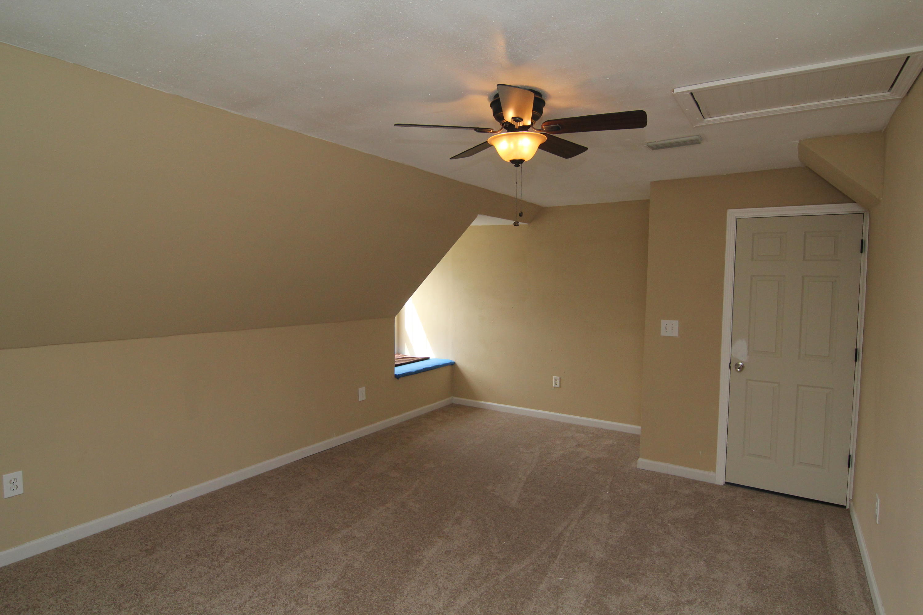 161 6th Street Santa Rosa Beach, FL 32459 - Photo 8 of 13 an empty room with a chandelier fan and windows