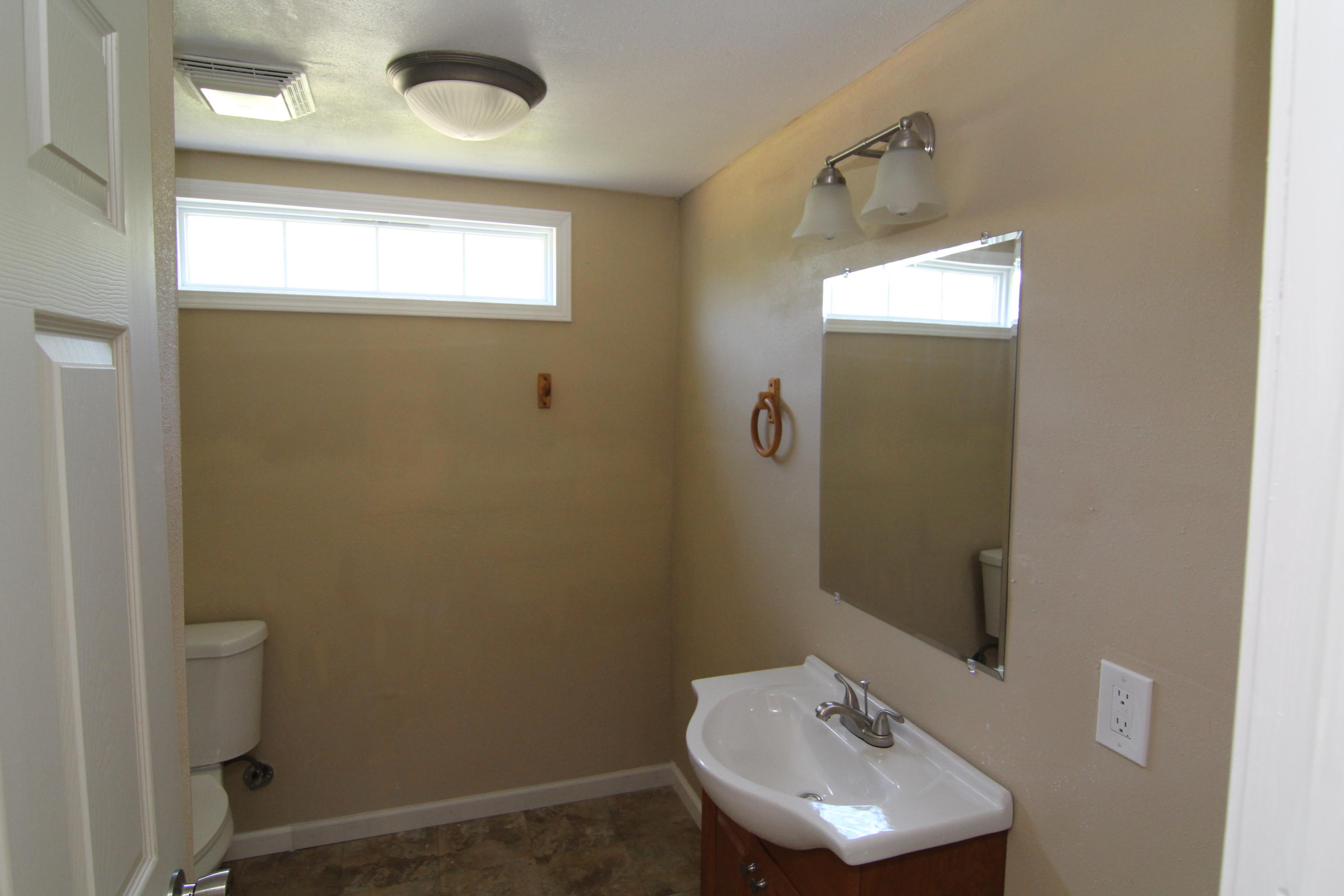 161 6th Street Santa Rosa Beach, FL 32459 - Photo 10 of 13 a bathroom with a sink toilet and mirror