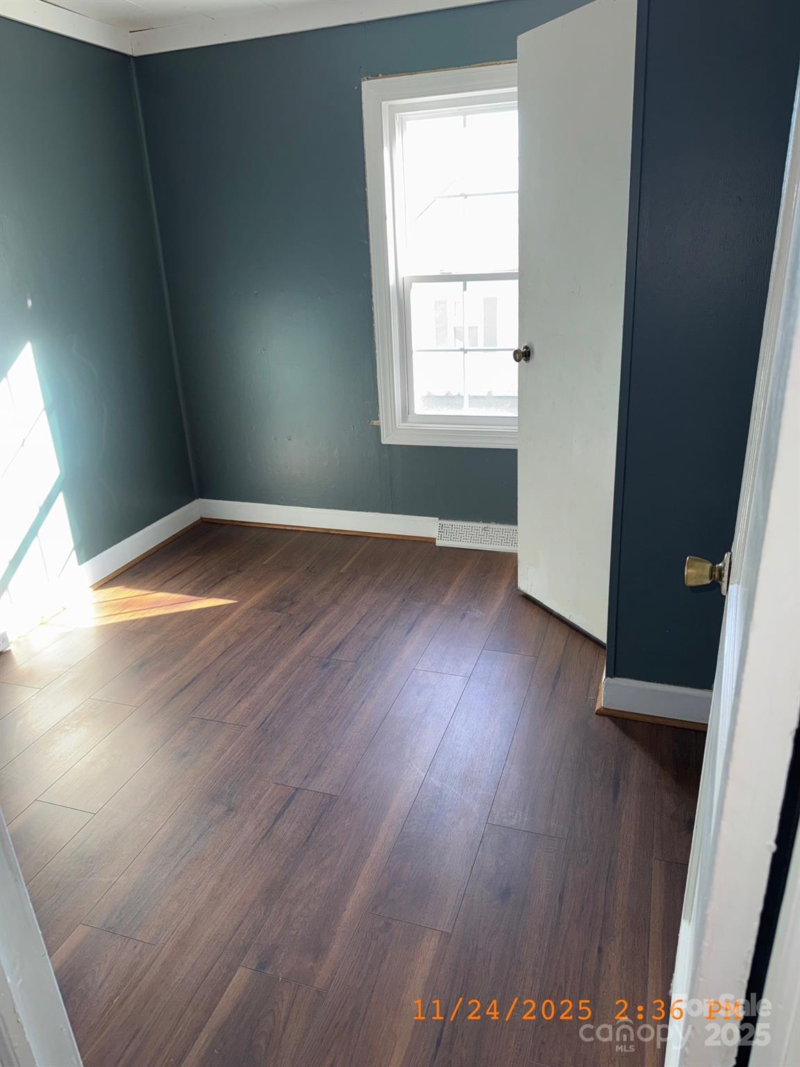 1217 Roberdell Road Rockingham, NC 28379 - Photo 11 of 12 an empty room with wooden floor and windows