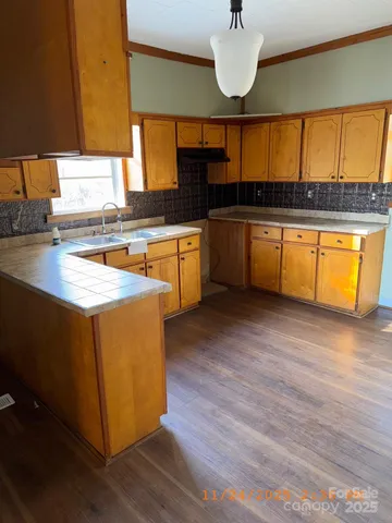 a kitchen with stainless steel appliances granite countertop a sink and a stove