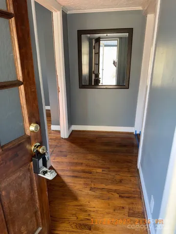 a view of a room with wooden floor and a window