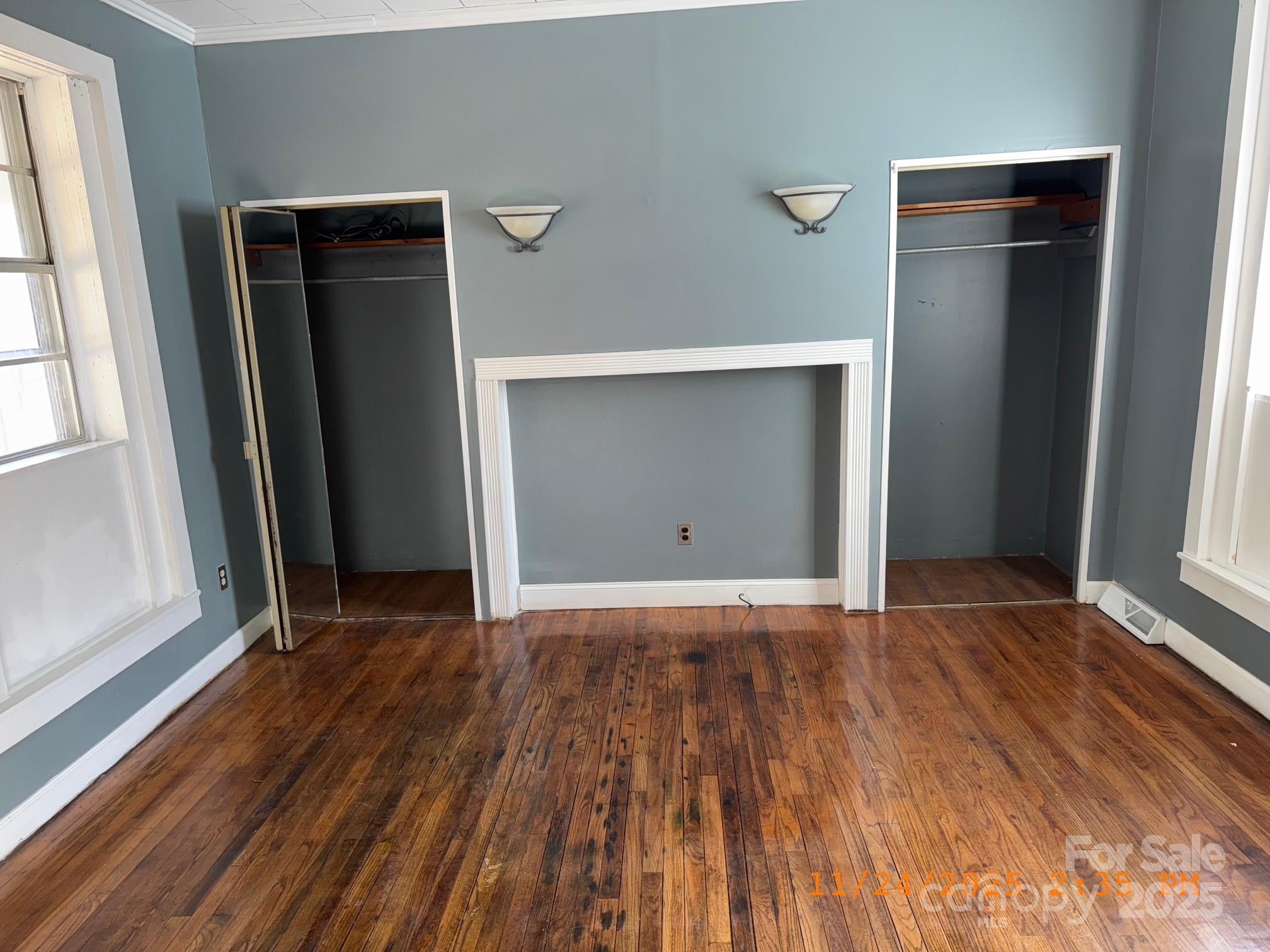 1217 Roberdell Road Rockingham, NC 28379 - Photo 6 of 12 an empty room with wooden floor and windows