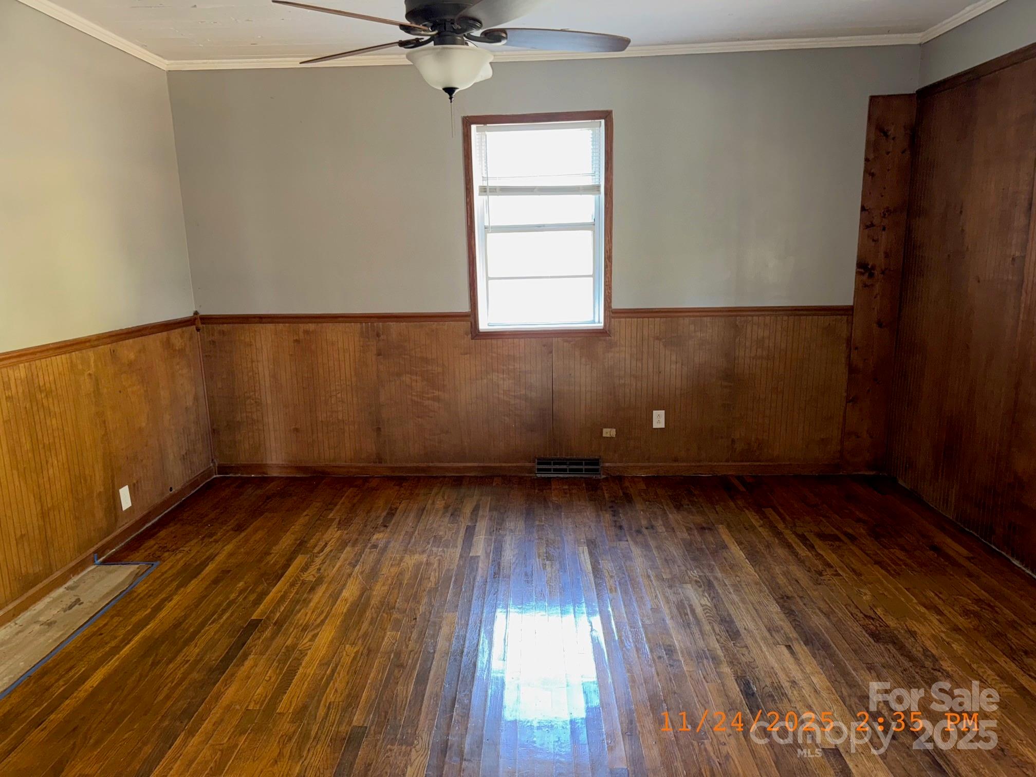 1217 Roberdell Road Rockingham, NC 28379 - Photo 7 of 12 an empty room with wooden floor and windows