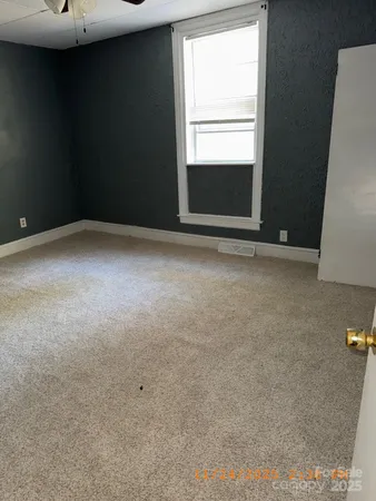 a view of an empty room with a fireplace