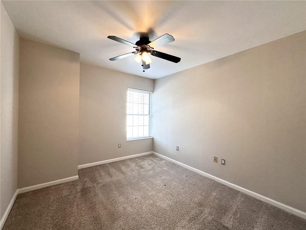199 14th Street Northeast, Unit 1609 Atlanta, GA 30309 - Photo 11 of 22 an empty room with windows and fan