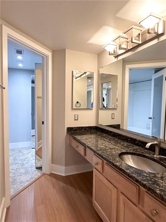 199 14th Street Northeast, Unit 1609 Atlanta, GA 30309 - Photo 14 of 22 a bathroom with a granite countertop double vanity sink and mirror