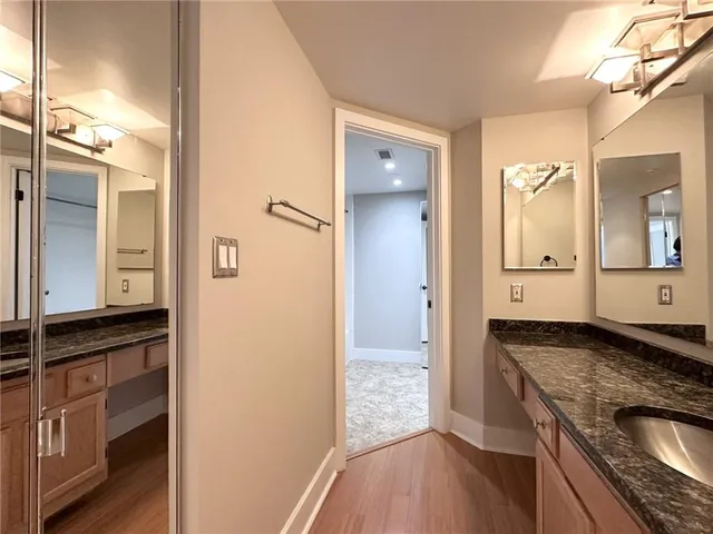 a view of a granite countertop kitchen counter space a sink and a refrigerator