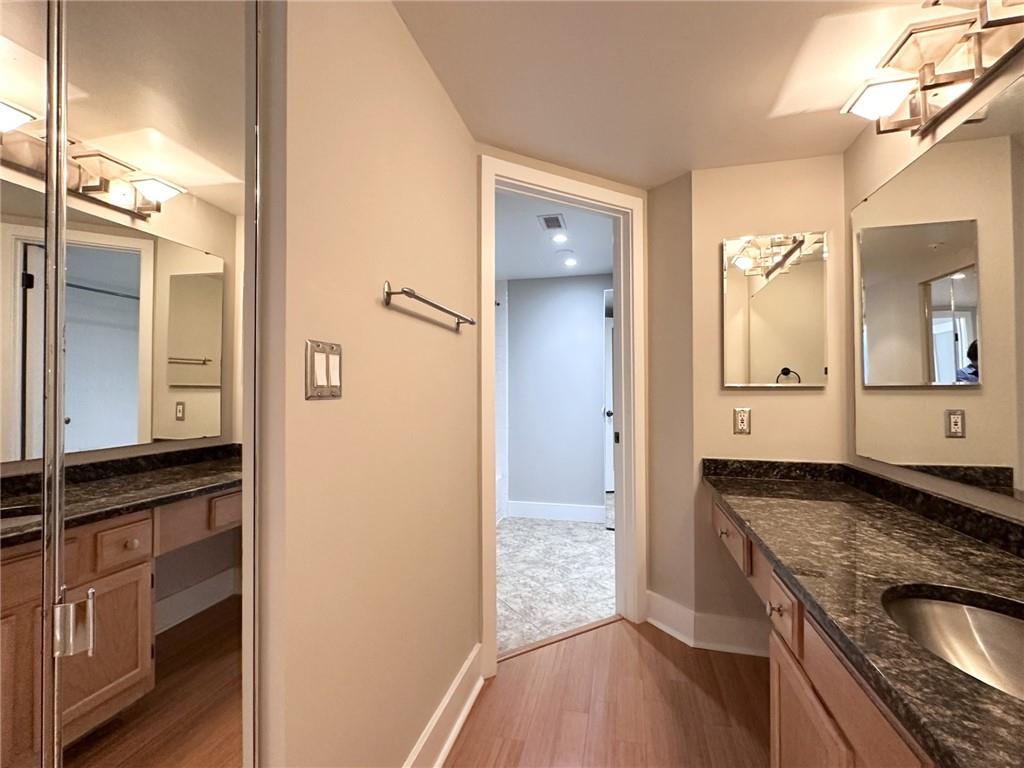 199 14th Street Northeast, Unit 1609 Atlanta, GA 30309 - Photo 19 of 22 a view of a granite countertop kitchen counter space a sink and a refrigerator