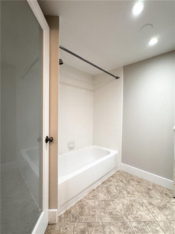 199 14th Street Northeast, Unit 1609 Atlanta, GA 30309 - Photo 20 of 22 a bathroom with a bathtub and a shower