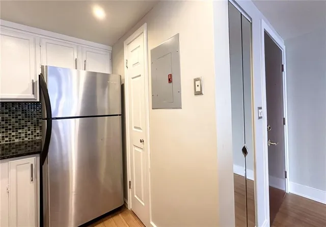 a view of a refrigerator in kitchen and wooden floor