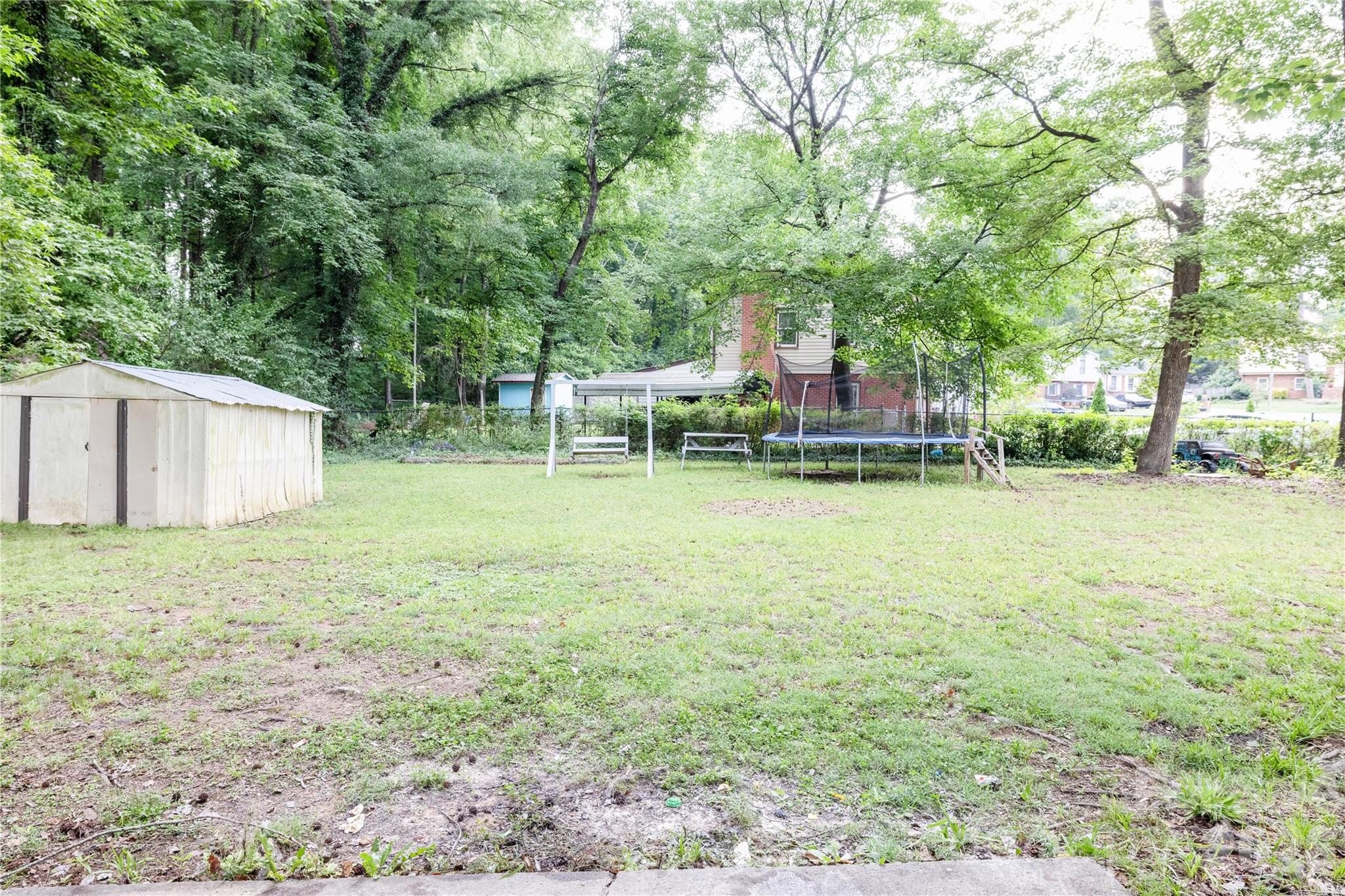 2545 Cedarwild Road Charlotte, NC 28212 - Photo 23 of 25 a backyard of a house with table and chairs
