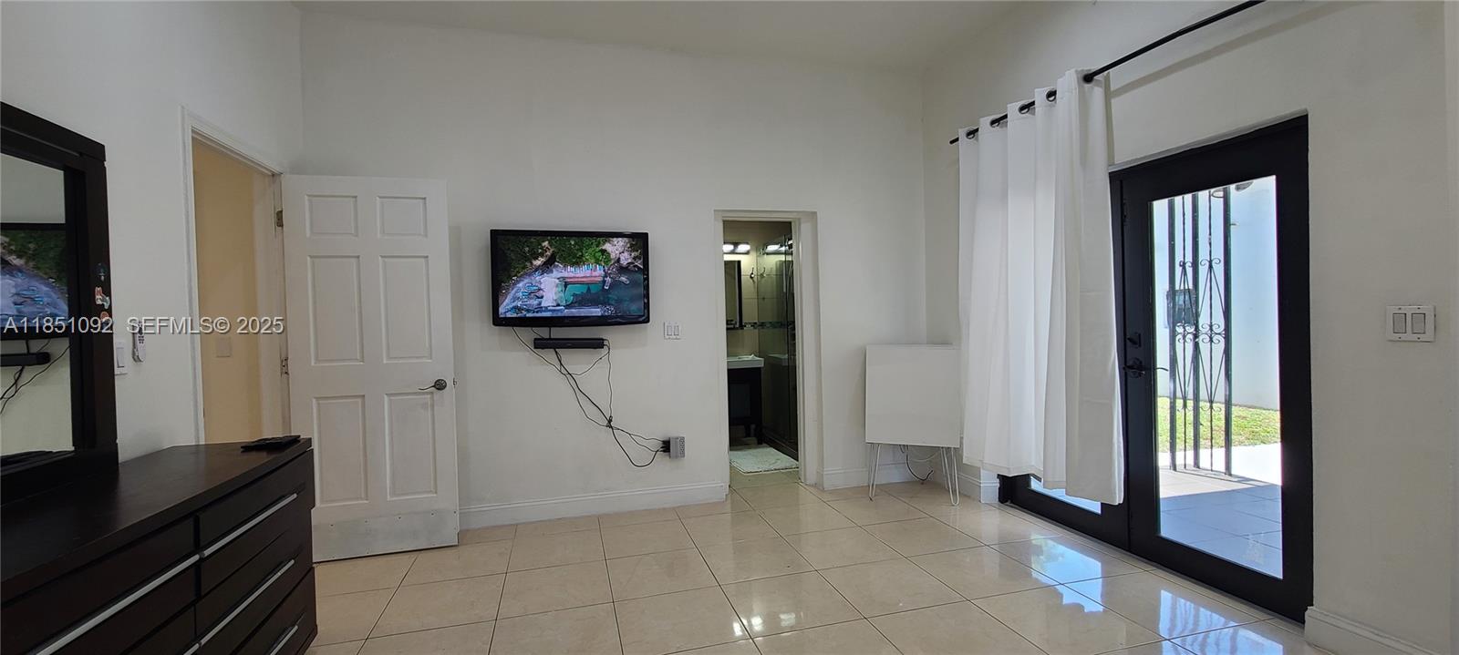 1721 Southwest 24th Terrace Miami, FL 33145 - Photo 50 of 80 a view of a hallway with workspace and a flat screen tv