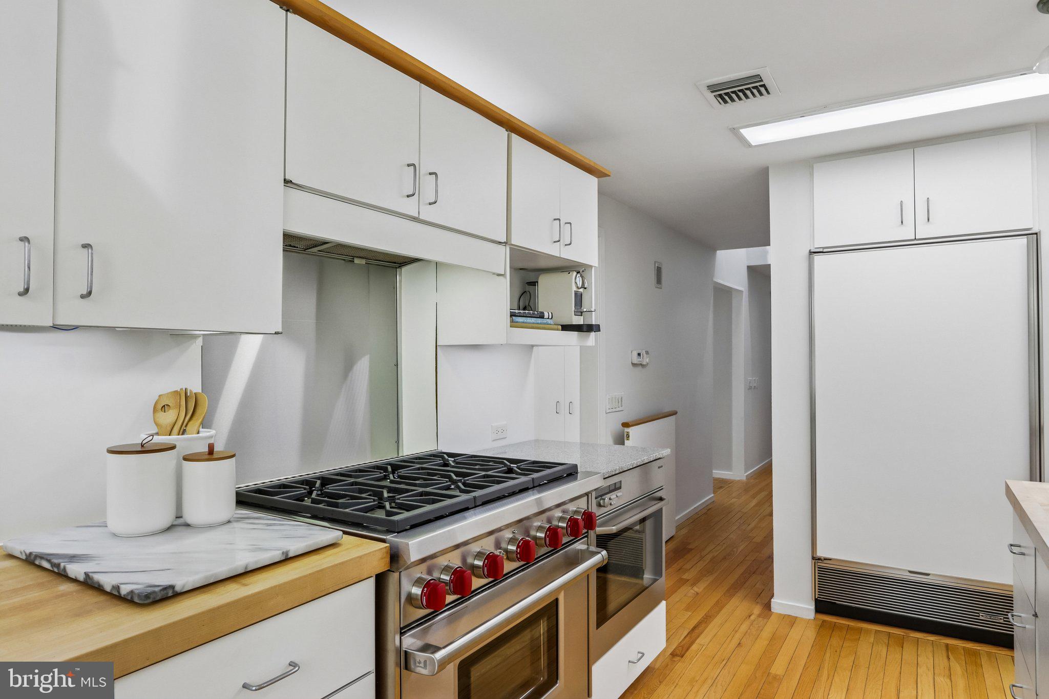 1673 Paper Mill Road Jenkintown, PA 19046 - Photo 24 of 73 a kitchen with granite countertop a stove and a refrigerator