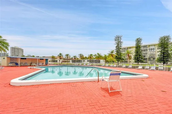 a view of a swimming pool with a lawn chairs