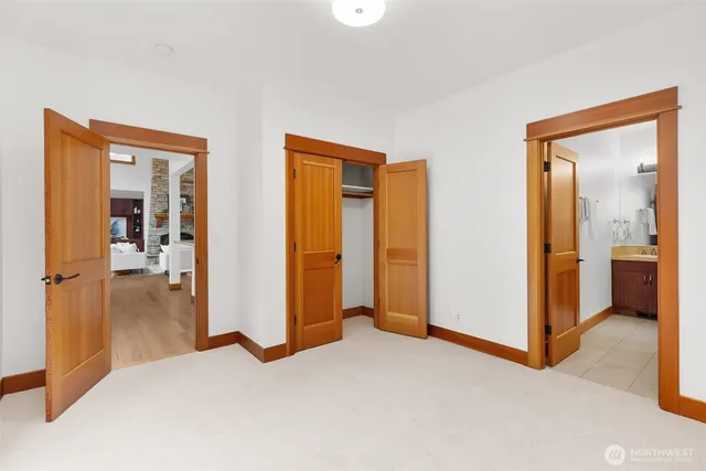 a view of a bedroom with bathroom and front door