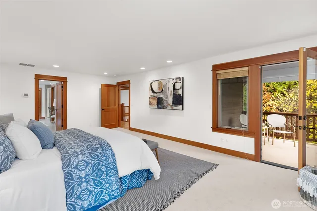 a spacious bedroom with a large bed and a large window