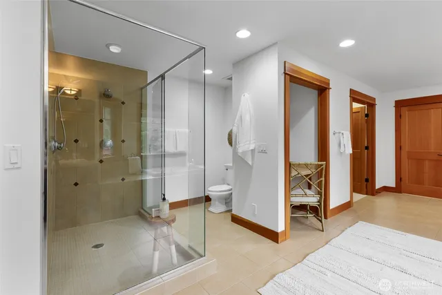 a bathroom with a glass shower door and a sink