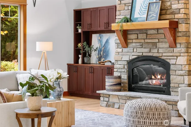 a living room with furniture a fireplace and a potted plant