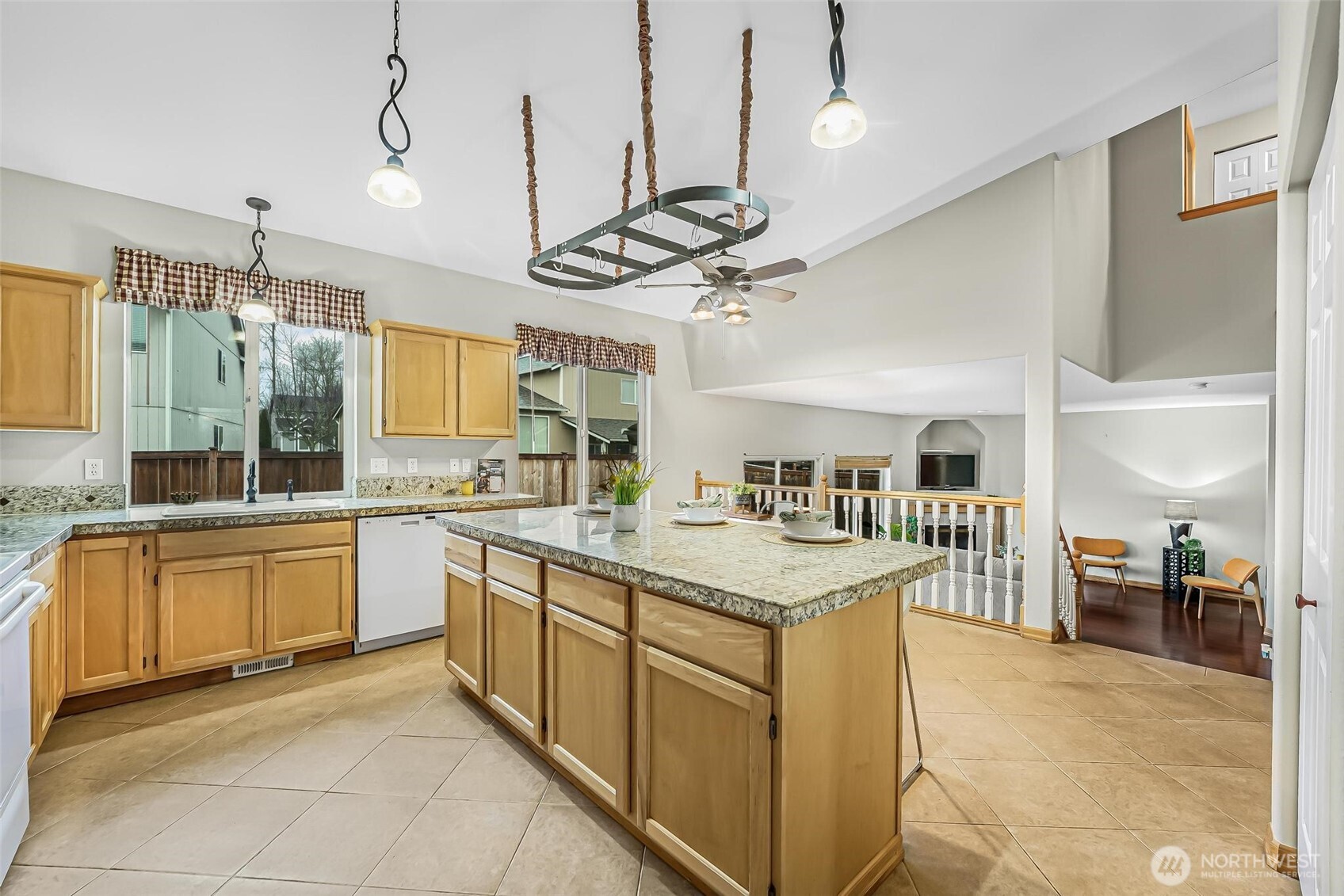 21012 Springhaven Way East Bonney Lake, WA 98391 - Photo 11 of 39 a kitchen with stainless steel appliances granite countertop a sink and a refrigerator