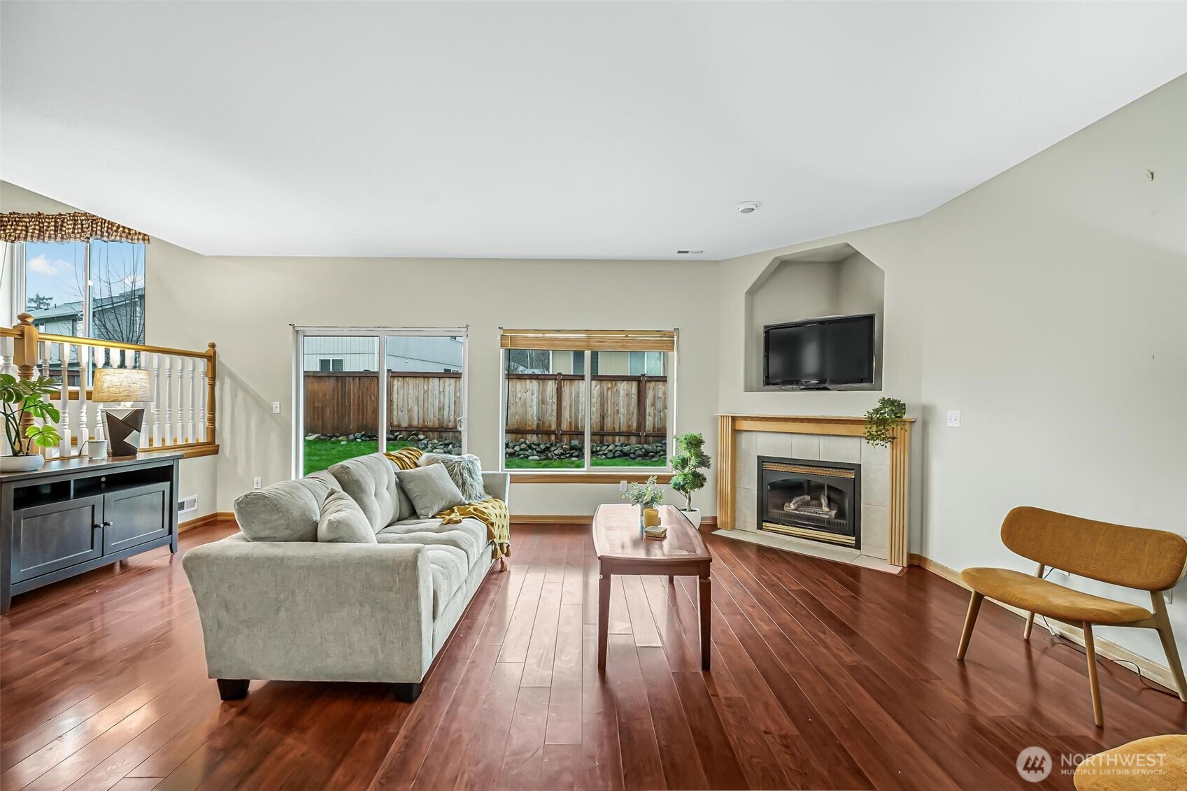 21012 Springhaven Way East Bonney Lake, WA 98391 - Photo 18 of 39 a living room with furniture a fireplace and a flat screen tv